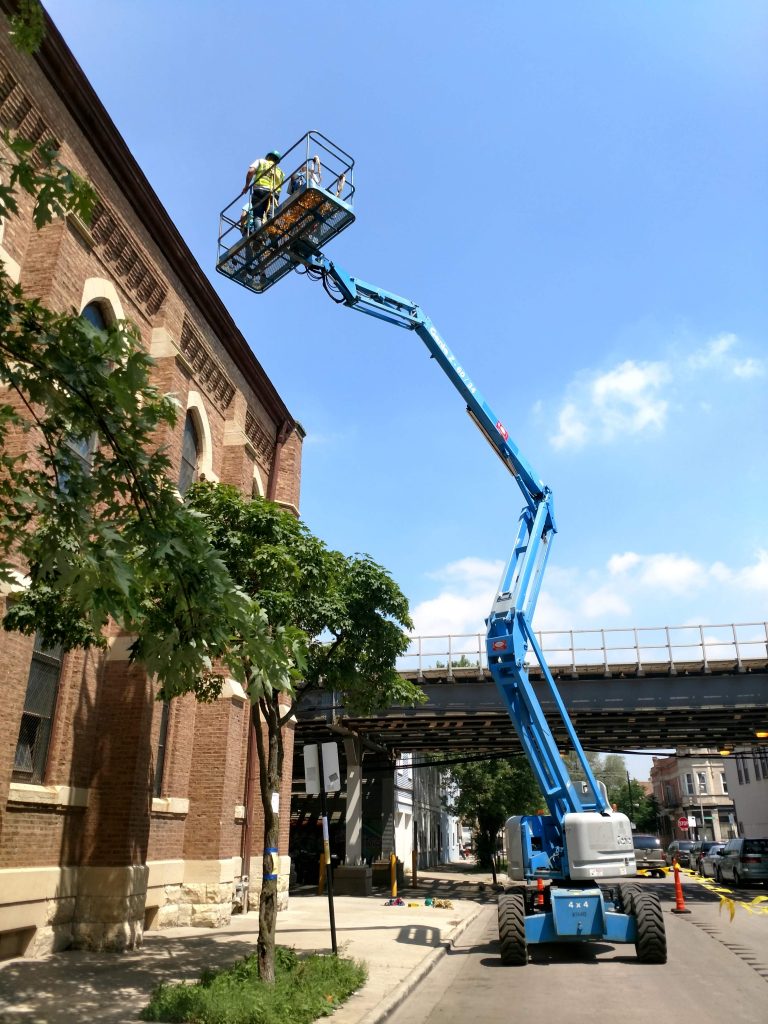 Genie Z-60/34 RT Rough Terrain Articulating Boom Extended Rear View